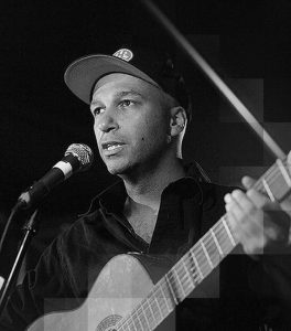 Tom Morello singing and playing the guitar.