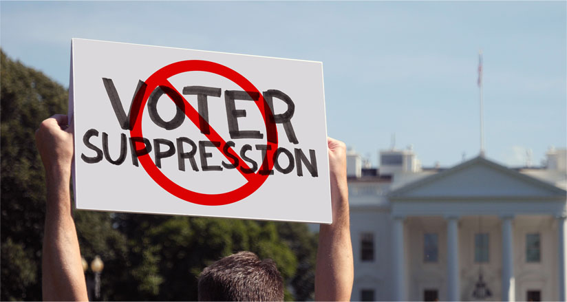 WASHINGTON, DC - Circa March, 2021 - A man waves a handmade STOP VOTER SUPPRESSION protest sign outside the White House_