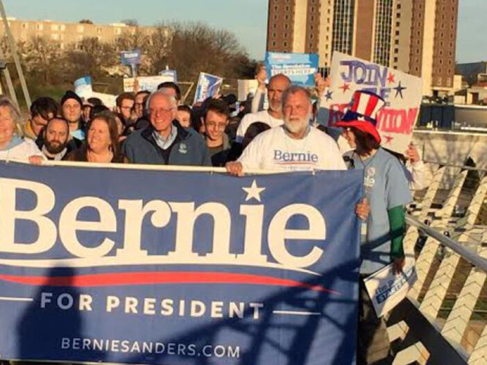 Bernie supporters carrying a Bernie for President banner