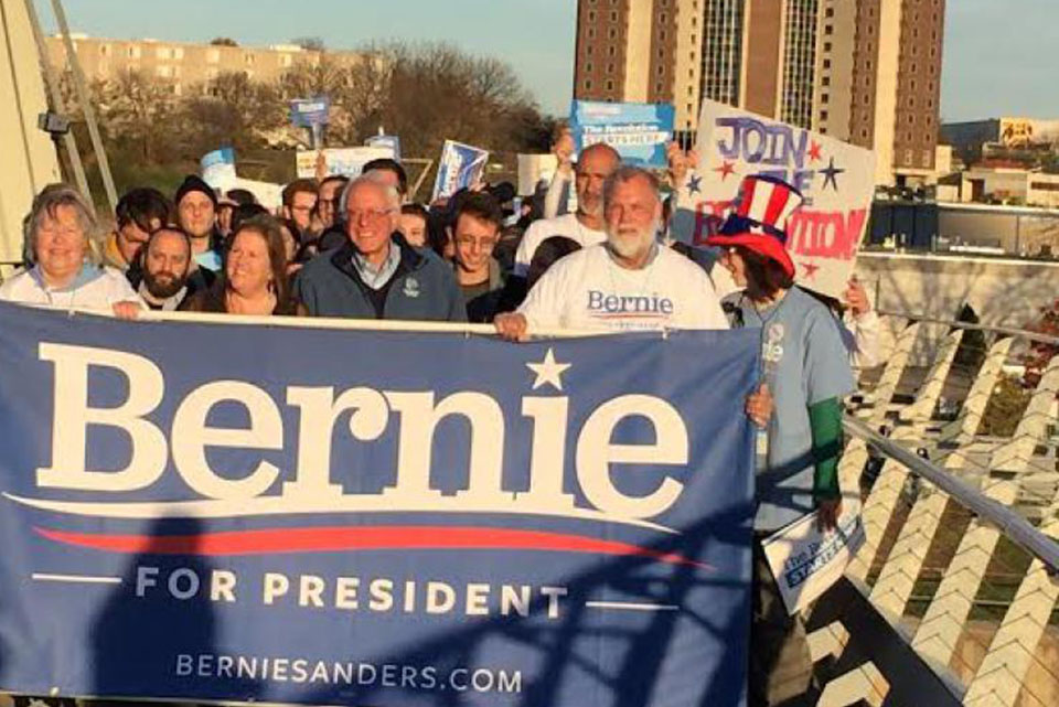 Bernie supporters carrying a Bernie for President banner