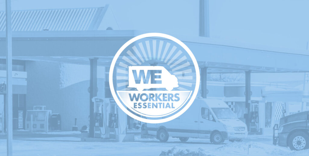 Workers Essential Logo in front of Amazon delivery trucks at a gas station.